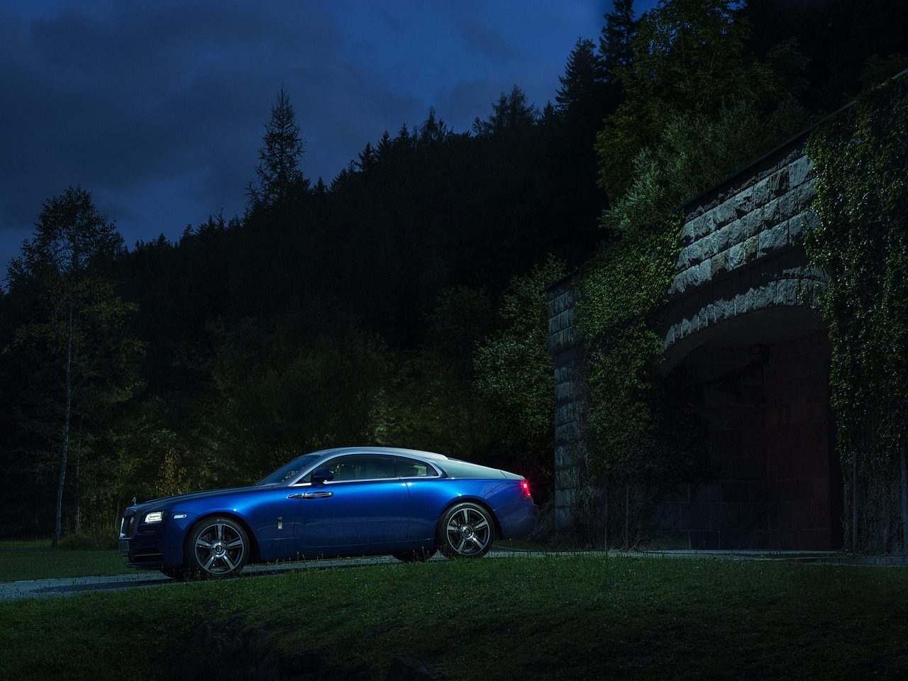 Blue sports car at night