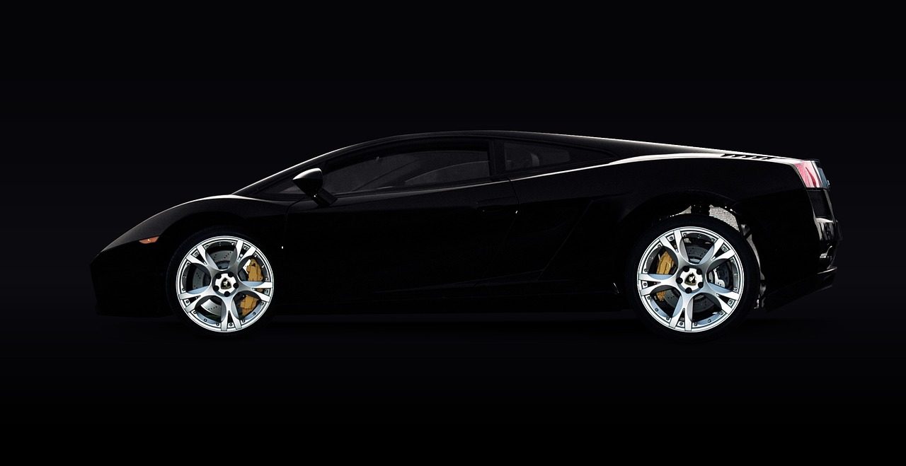 Dark luxury coupe under low light