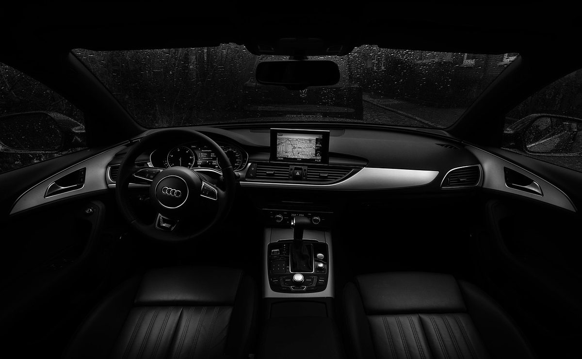 Dark car cockpit and steering wheel