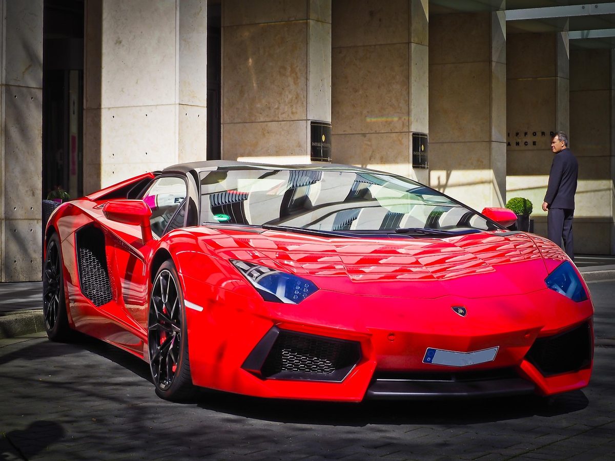 Red supercar with scissor doors open
